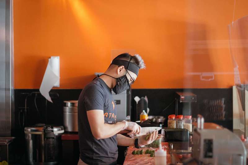 Man prepares food in Atarashi